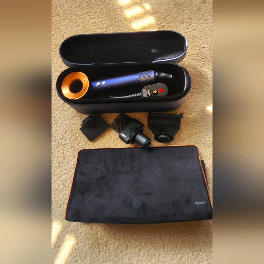 Dyson hair dryer with accessories and complimentary travel bag